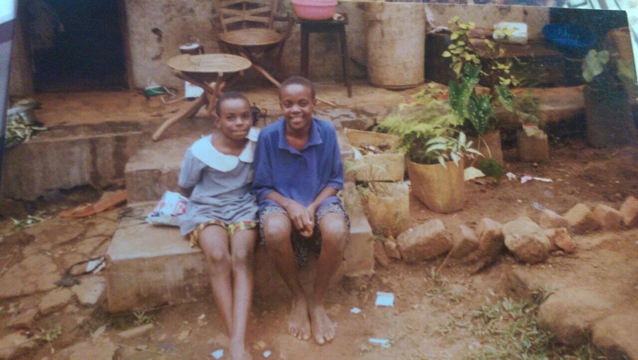 Catherine Nakalembe and her little sister Norah in front of their house