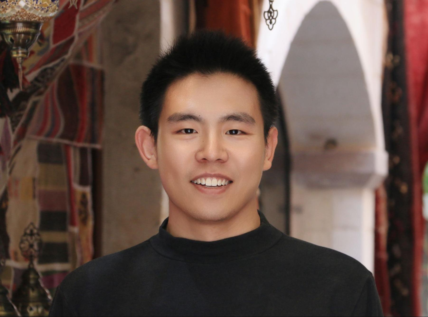 Xueyuan (Eric) Gao smiles with Princeton building in the background