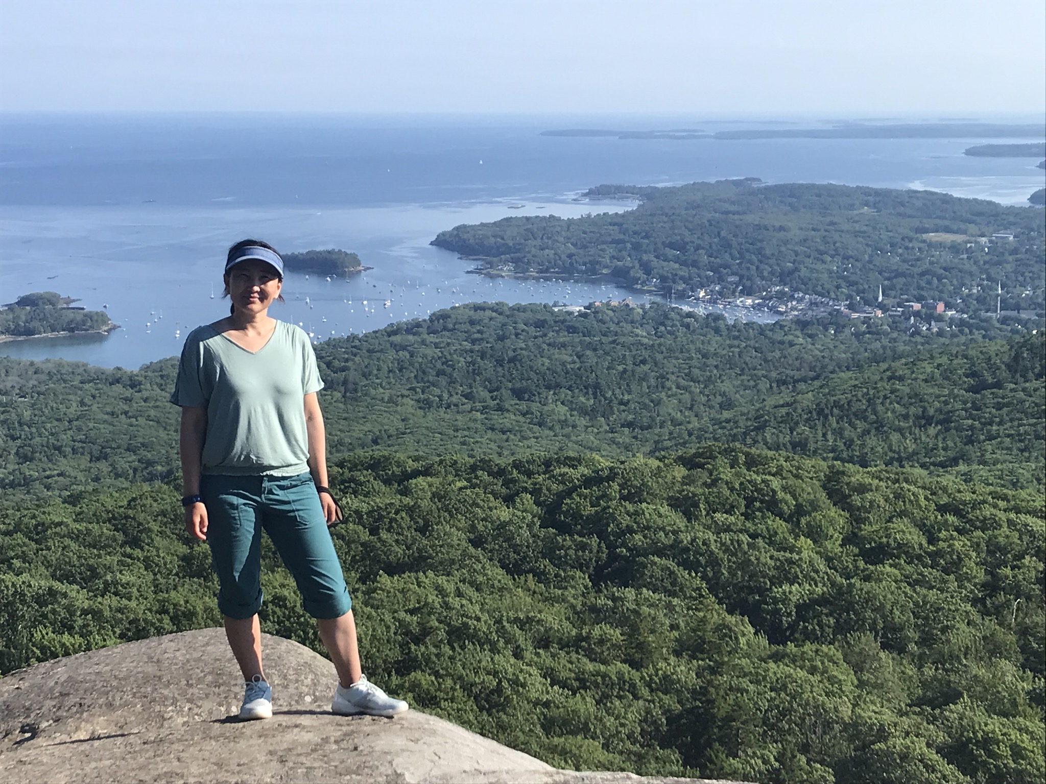 Aynoor Ford poses for a view from the summit of Mount Megunticook at Camden Hills State Park, Maine.