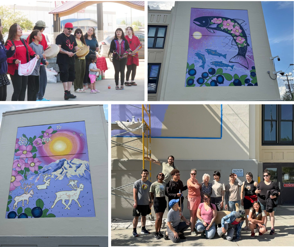 A four-panel collage celebrating a community mural project. The top-left panel shows a group of people singing and drumming outdoors. The bottom-right panel shows a large group of artists posing together in front of a wall with scaffolding. The remaining two panels show close-ups of the completed nature-themed murals on the building's exterior: one depicting a large fish with pink flowers and wild berries, and the other featuring a bright sun, snowy mountains, and caribou.
