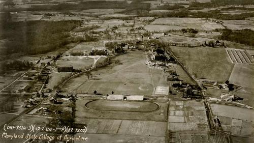 A 1926 aerial view of the Maryland Agricultural College shows the old stadium where Fraternity Row now stands.