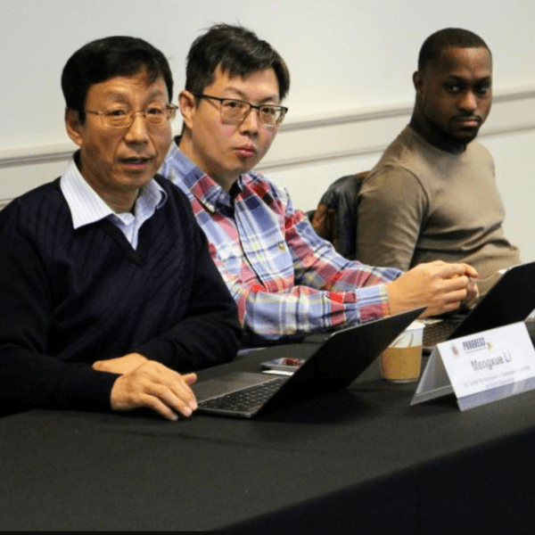 Mengxue Li (left) and Ruibo Han (middle) presenting their PROGRESS project to the Alliance of Concerned Men in December 2024.