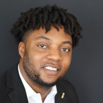 PhD student Michaelmary Chukwo smiles in professional attire.
