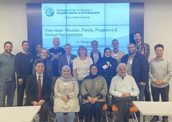 Group photo of MENA Space Leaders visit, posing in front of a large presentation screen.