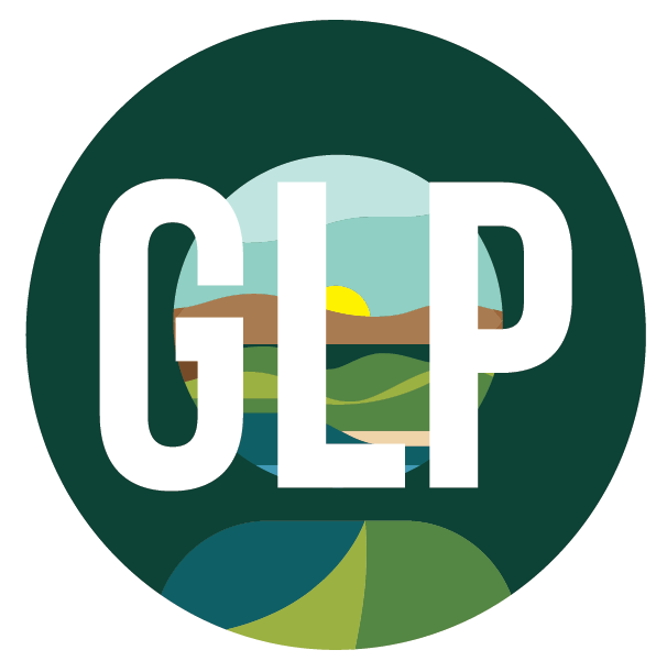 A circular logo with a dark green border and the bold, white letters "GLP" centered over a stylized landscape of rolling hills and a rising sun.