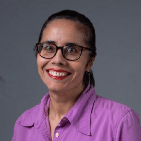 Renata Johnson is smiling, her hair in a ponytail. 