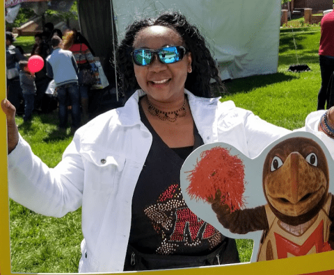 Lady with sunglasses, holding a banner.