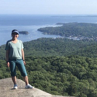 Aynoor Ford poses for a view from the summit of Mount Megunticook at Camden Hills State Park, Maine.