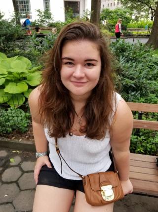 Image of Sasha sitting on a park bench